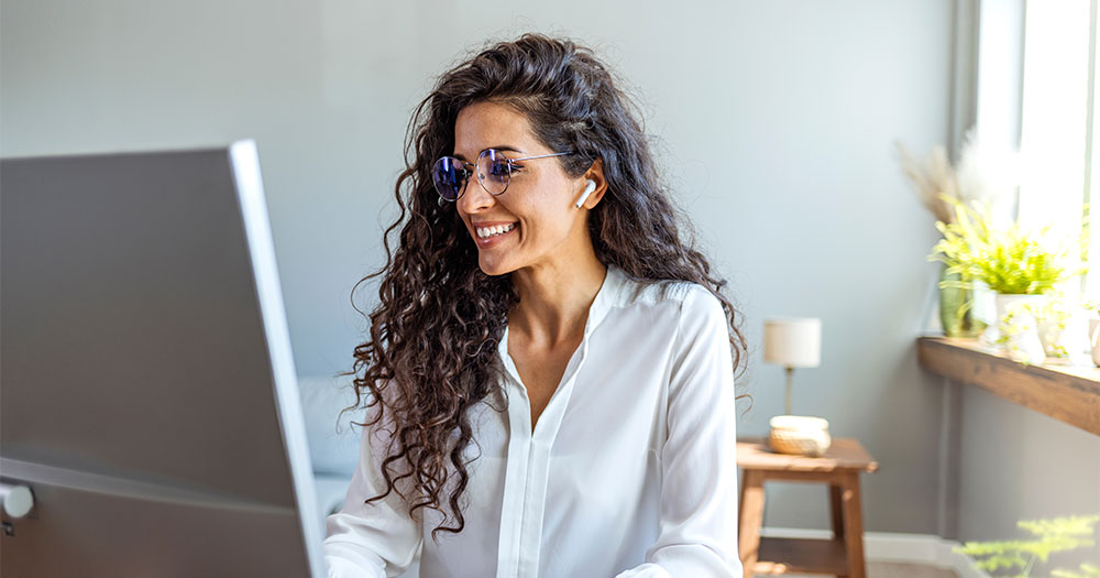 Person smiling at monitor